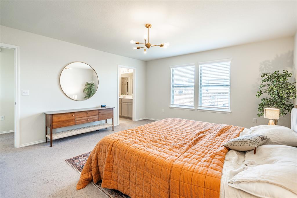 547 Saturnia Drive Georgetown, TX 78628 - Photo 34 of 39 a bedroom with a bed a chandelier and a window