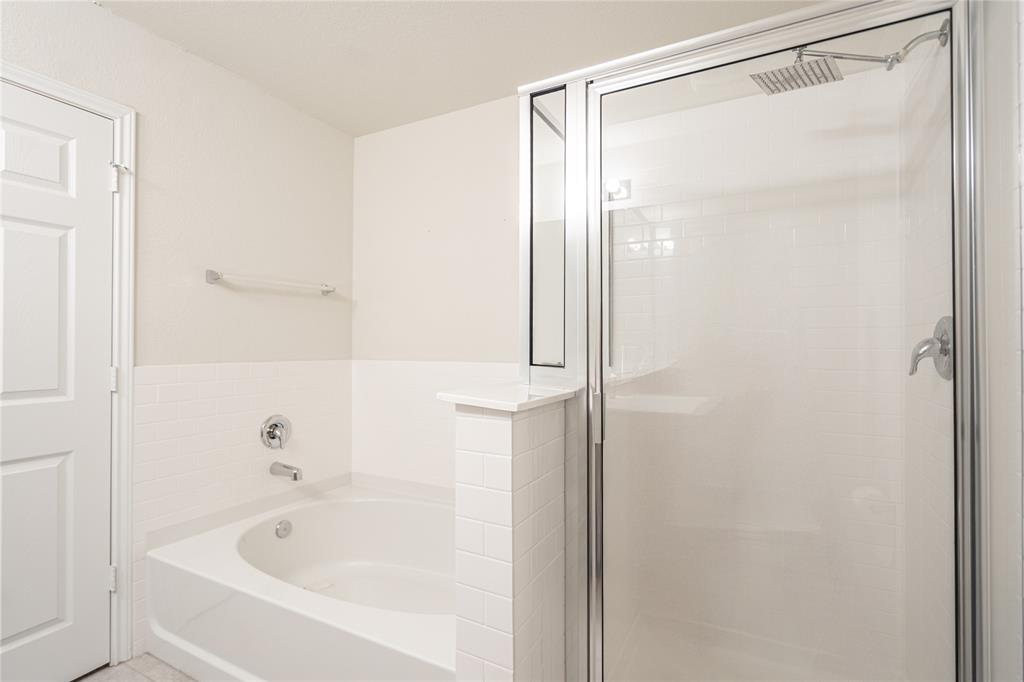 547 Saturnia Drive Georgetown, TX 78628 - Photo 37 of 39 a bathroom with a bathtub and a shower