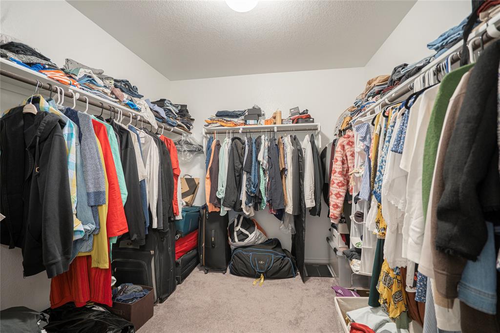 547 Saturnia Drive Georgetown, TX 78628 - Photo 38 of 39 a view of walk in closet with clothes