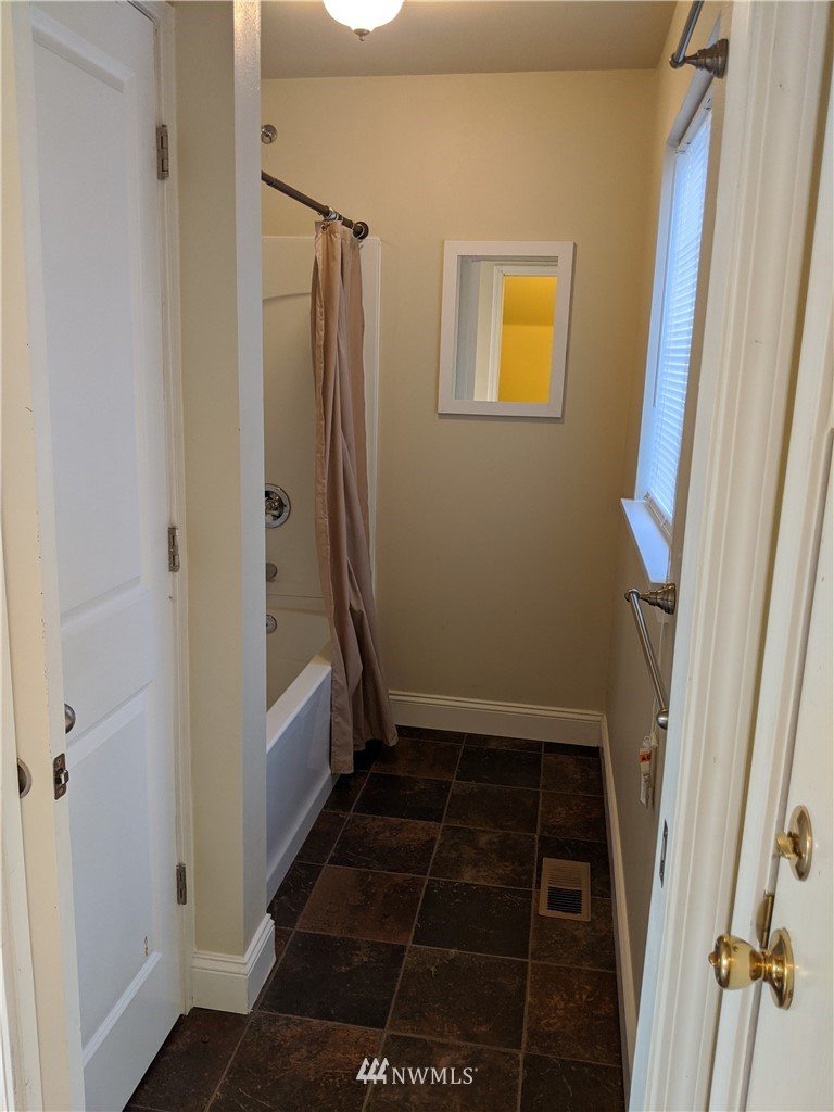 3224 Locust Avenue Bellingham, WA 98225 - Photo 11 of 28 a bathroom with a tub and a shower