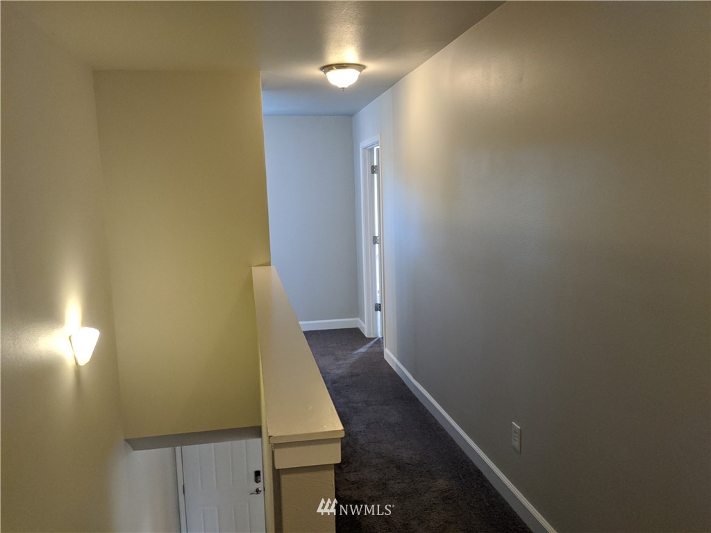 3224 Locust Avenue Bellingham, WA 98225 - Photo 19 of 28 a view of a hallway with wooden floor