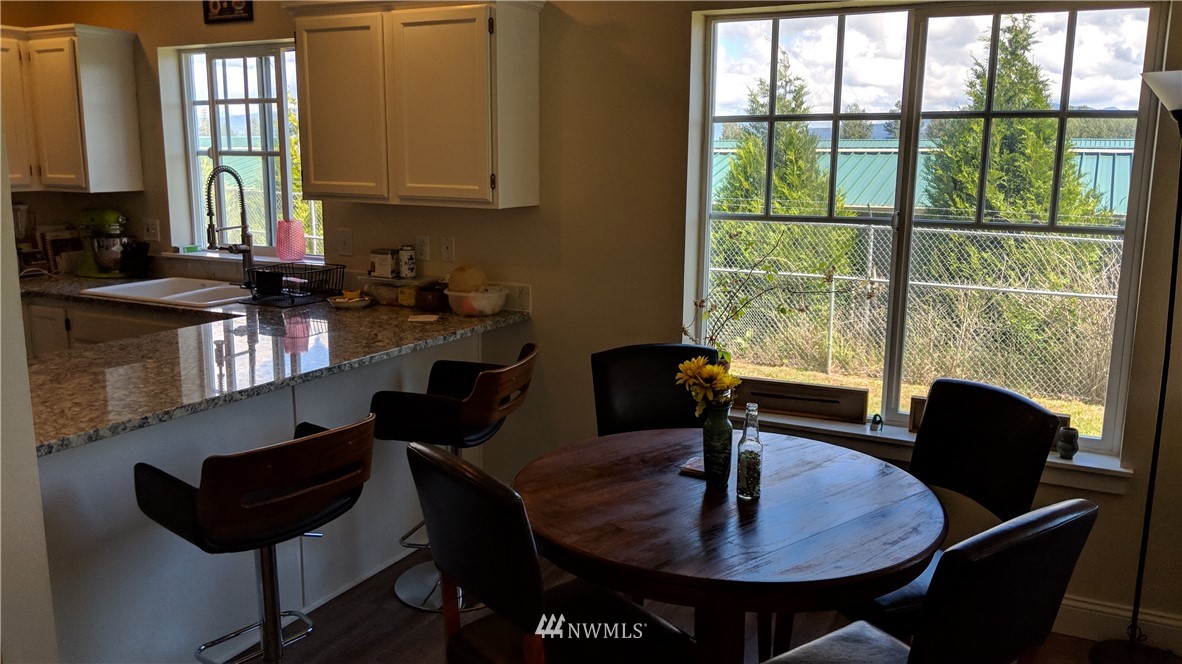 3224 Locust Avenue Bellingham, WA 98225 - Photo 27 of 28 a kitchen with a table chairs and a window