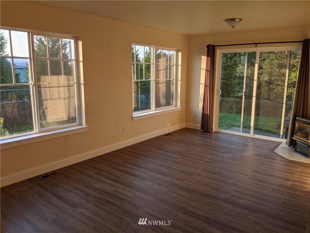 3224 Locust Avenue Bellingham, WA 98225 - Photo 8 of 28 a view of an empty room with wooden floor and a window