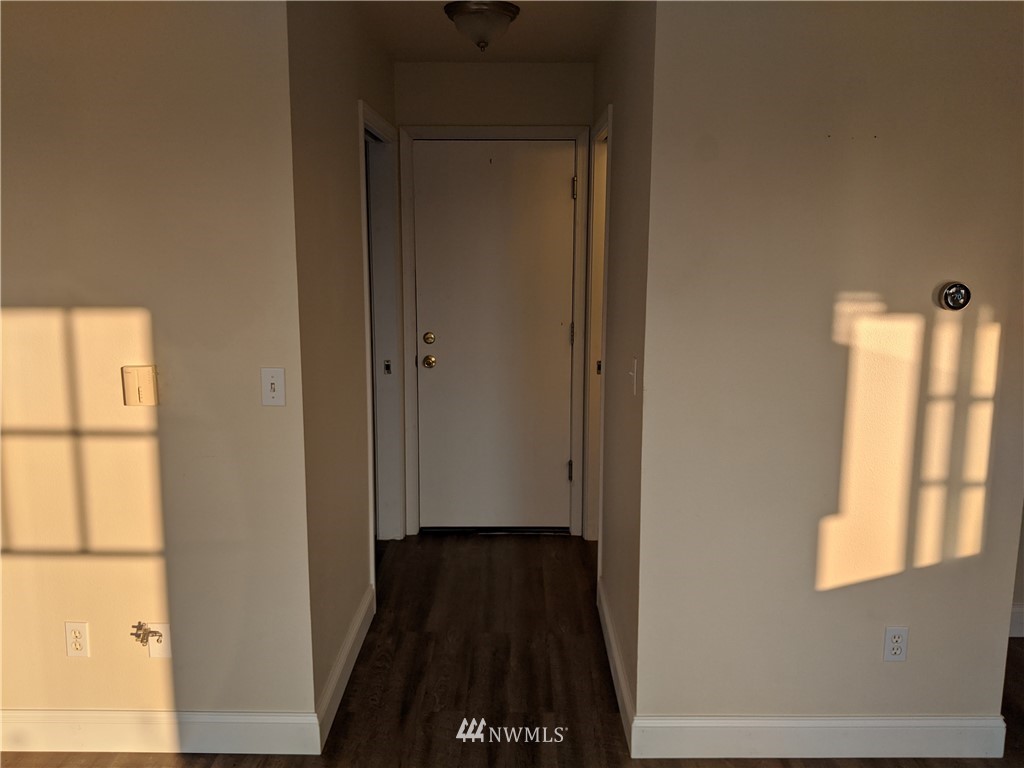 3224 Locust Avenue Bellingham, WA 98225 - Photo 10 of 28 a view of a hallway with wooden floor and a window