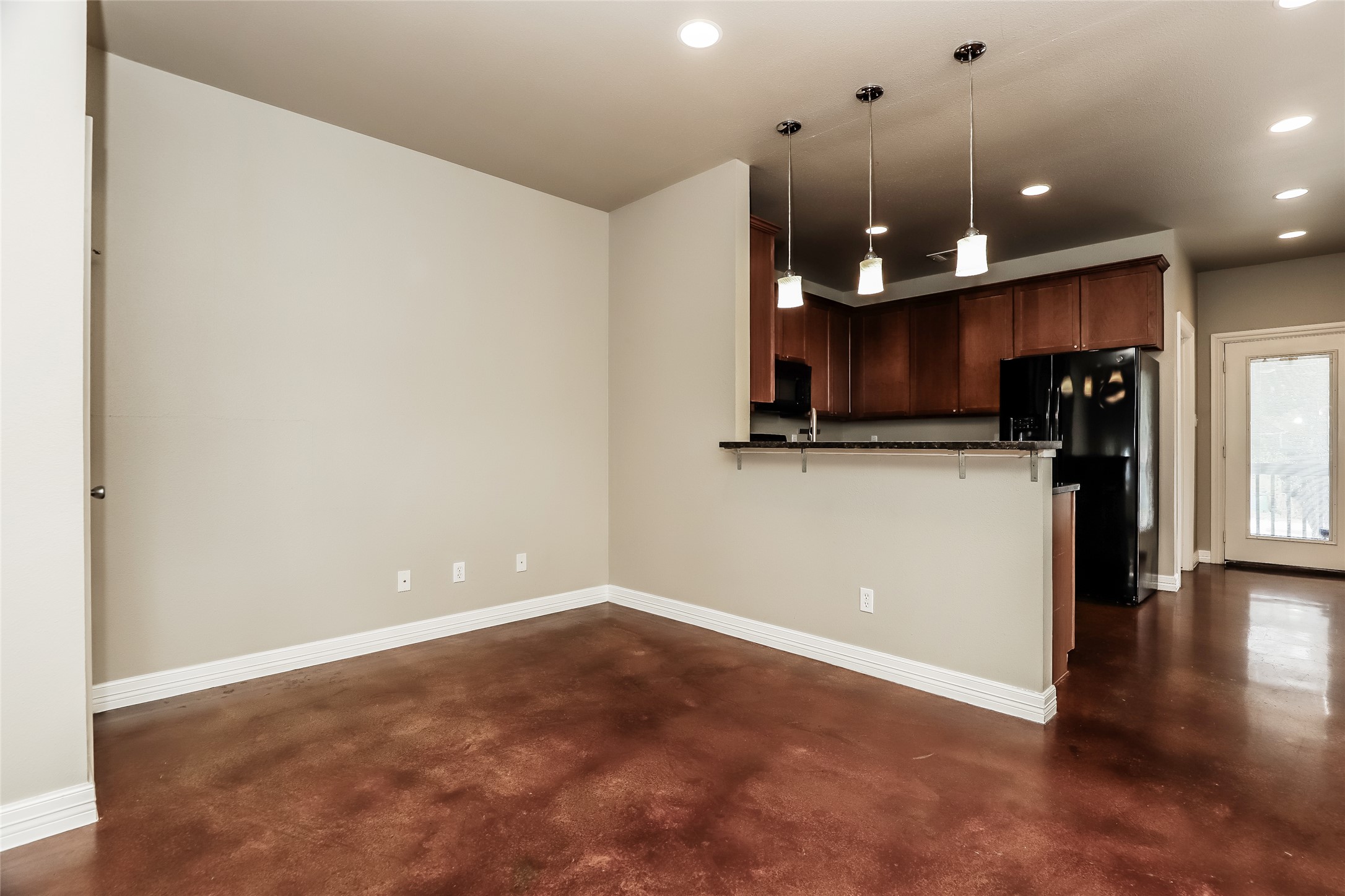 1701 Sanchez Street, Unit A Austin, TX 78702 - Photo 8 of 19 A versatile open-concept living area boasts a sleek kitchen with ample cabinet space, ready for personalization.