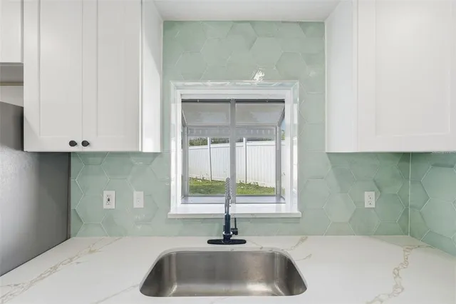 a view of wooden floor and windows in a room