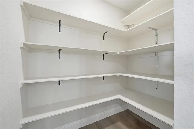 a spacious bathroom with a double vanity sink and a mirror