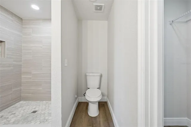 a view of a kitchen with a sink and a refrigerator
