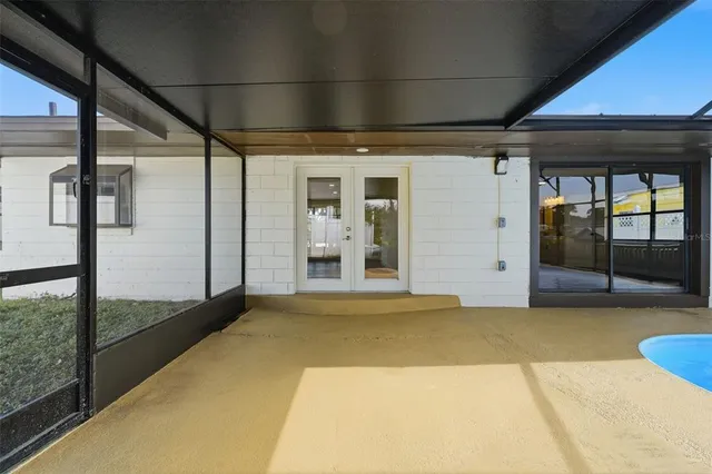 a view of a room with window and white walls