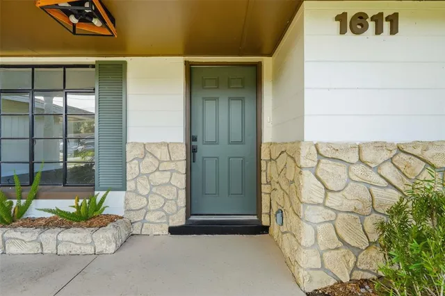 a view of kitchen with kitchen island and stainless steel appliances