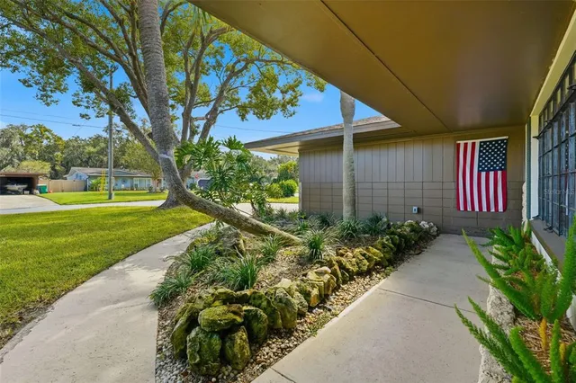a large white kitchen with kitchen island white cabinets and wooden floor