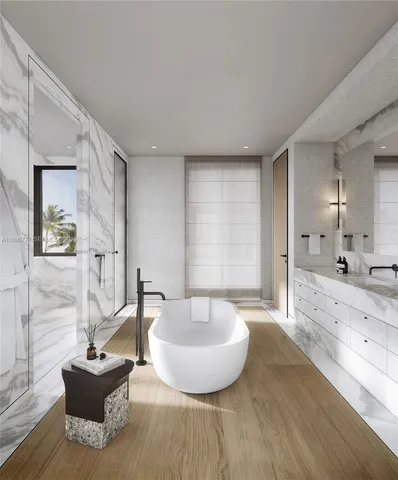a spacious bathroom with a tub sink and mirror