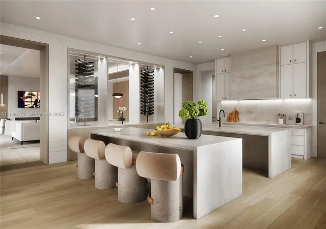 a large white dining hall with stainless steel appliances kitchen island granite countertop a dining table chairs and a large window