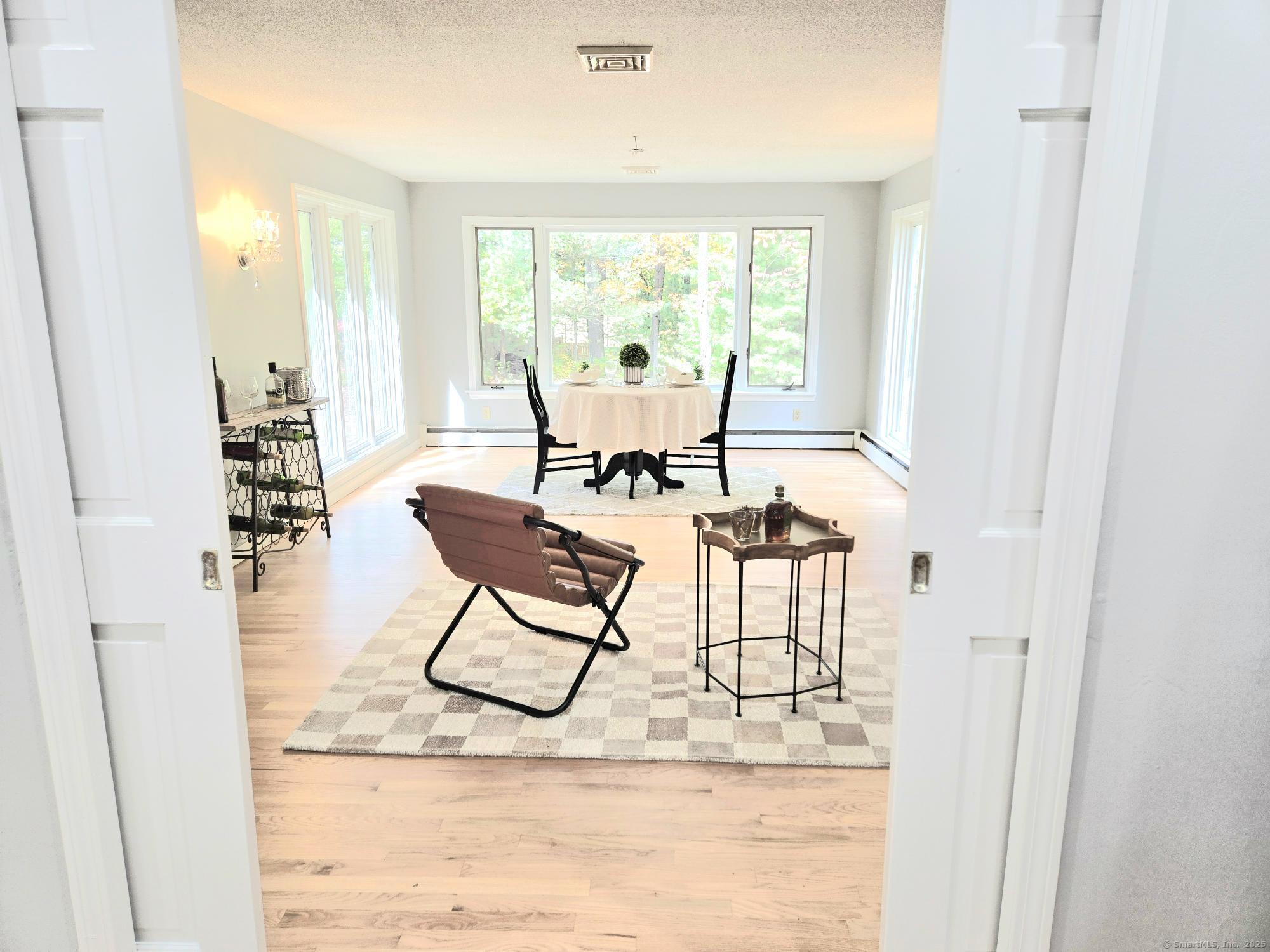 297 Wickham Road Glastonbury, CT 06033 - Photo 11 of 39 a living room with furniture and a large window