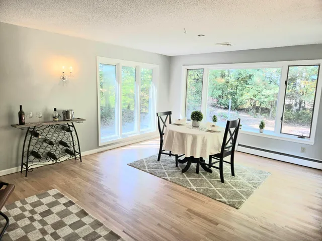 a large bed sitting in a bedroom next to a window