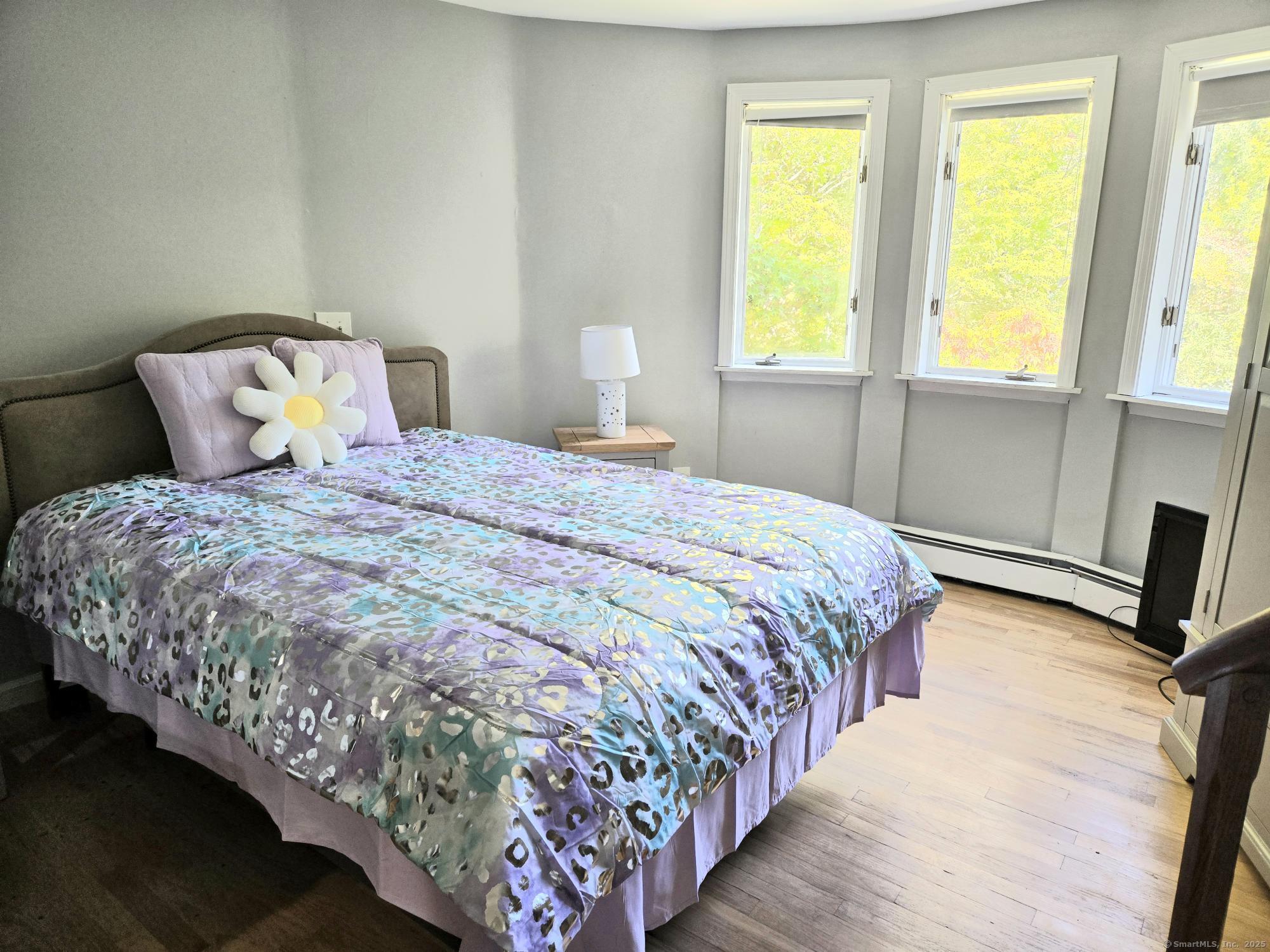 297 Wickham Road Glastonbury, CT 06033 - Photo 14 of 39 a large bed sitting in a bedroom next to a window