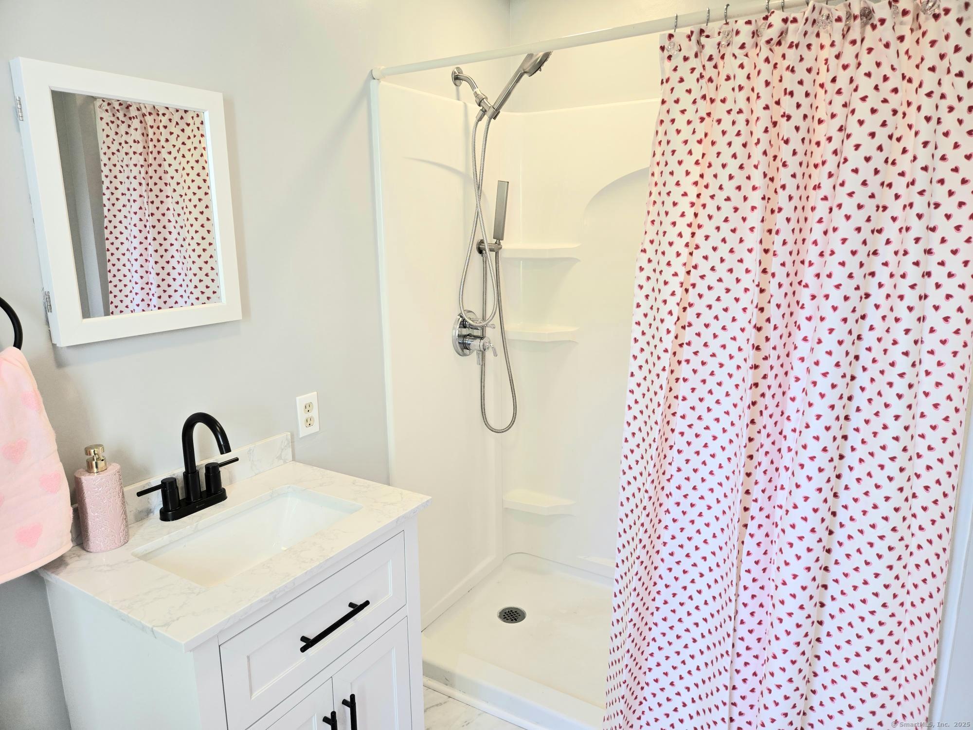 297 Wickham Road Glastonbury, CT 06033 - Photo 15 of 39 a bathroom with a shower curtain a sink and a shower