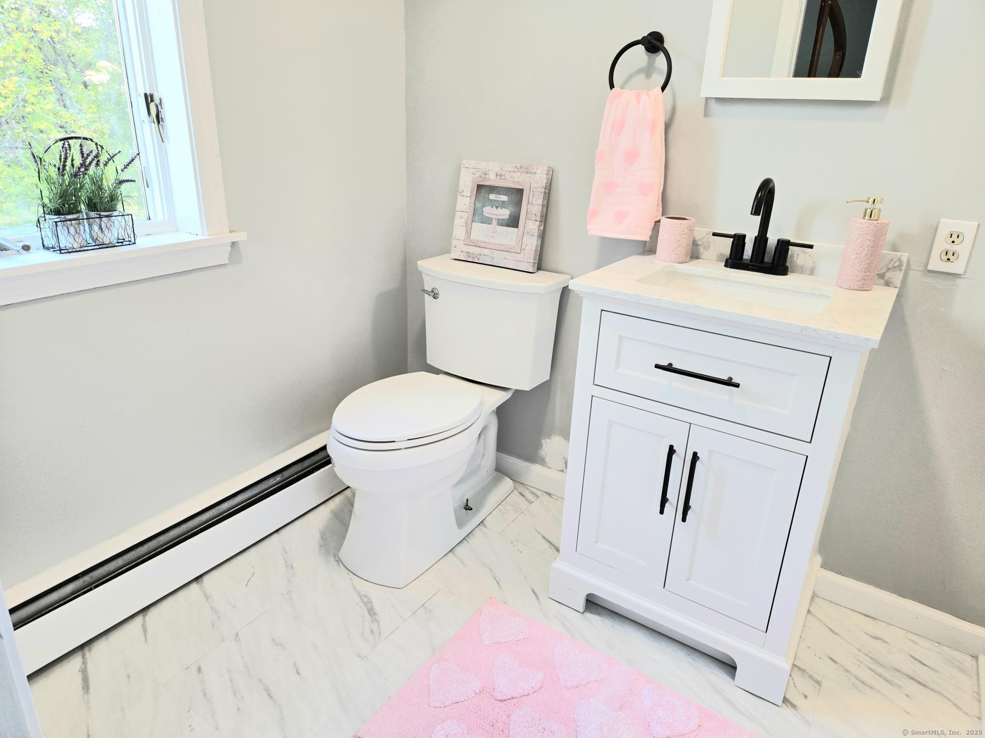 297 Wickham Road Glastonbury, CT 06033 - Photo 16 of 39 a white toilet sitting next to a bathroom sink