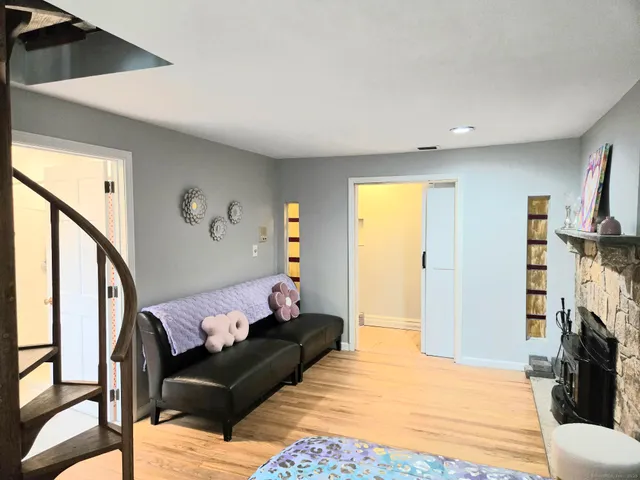 a bedroom with furniture and wooden floor