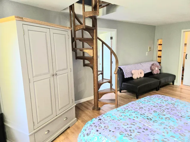 a bedroom with a bed and window