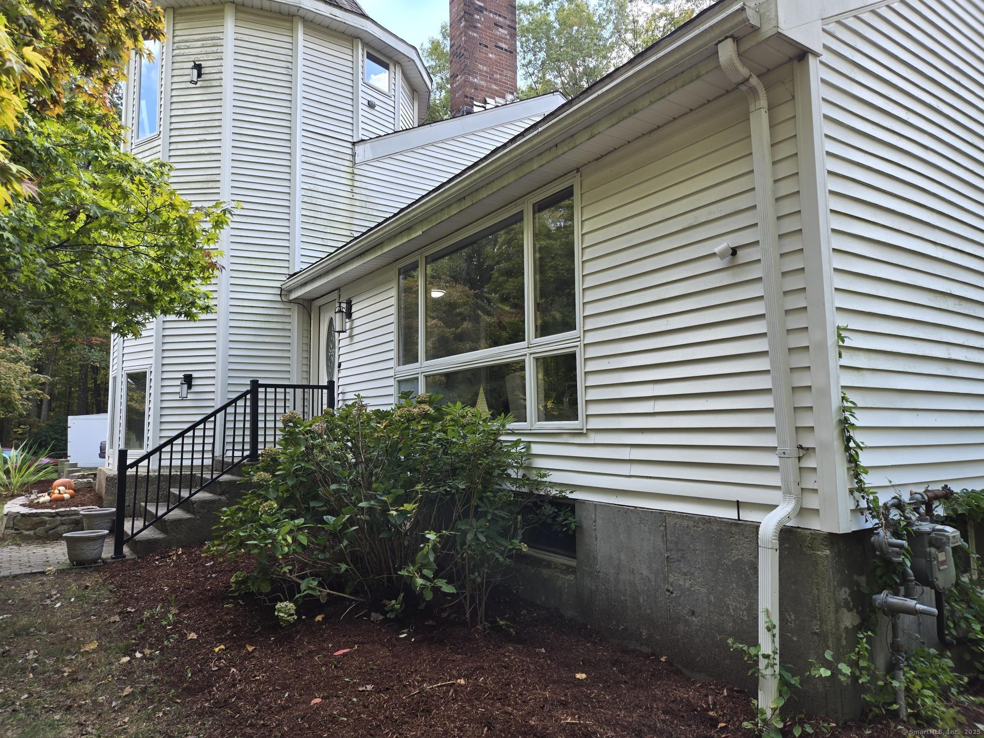 297 Wickham Road Glastonbury, CT 06033 - Photo 2 of 39 a view of a house with a yard and plants