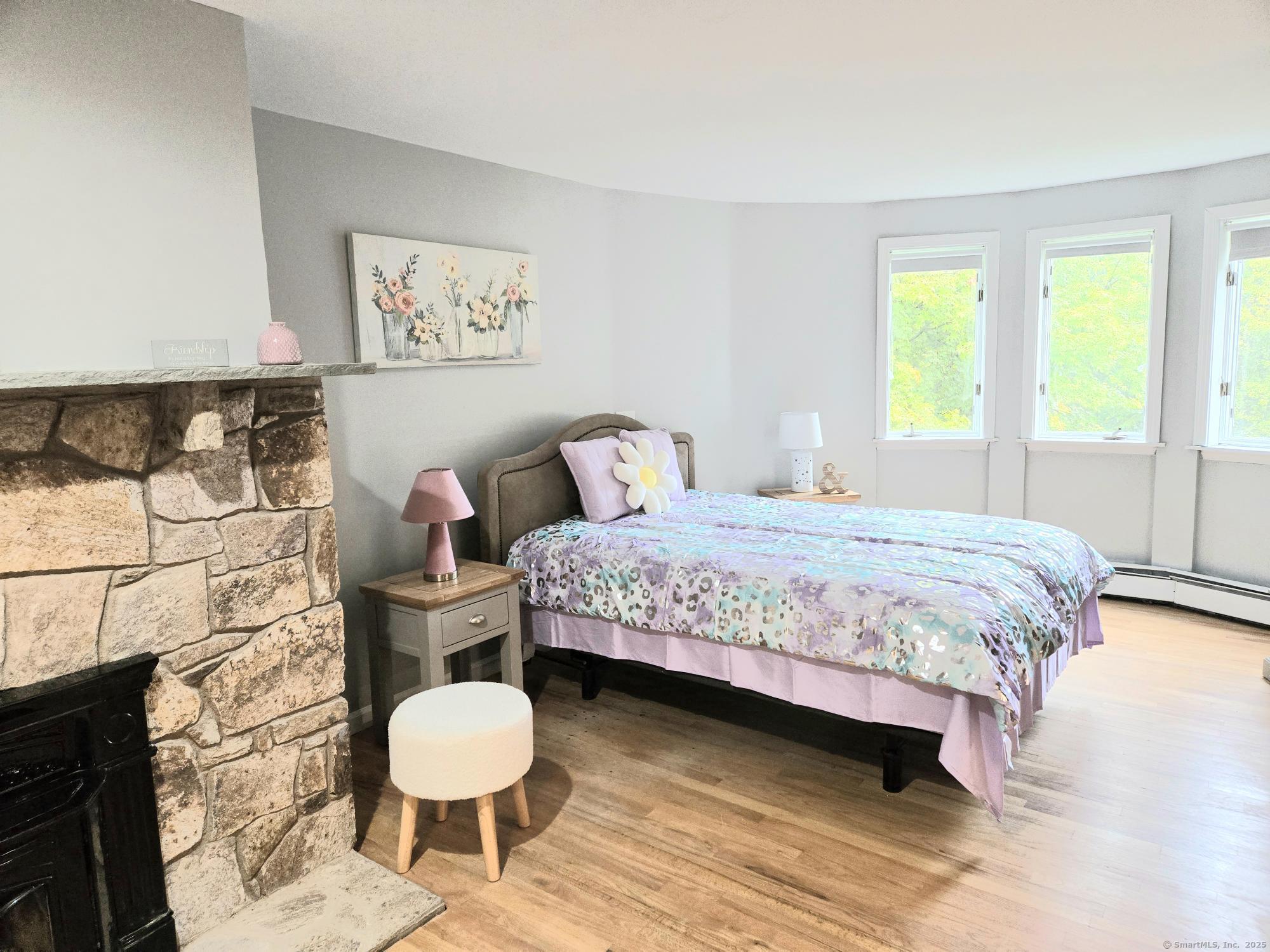 297 Wickham Road Glastonbury, CT 06033 - Photo 21 of 39 a bedroom with a bed and a chair with outer view