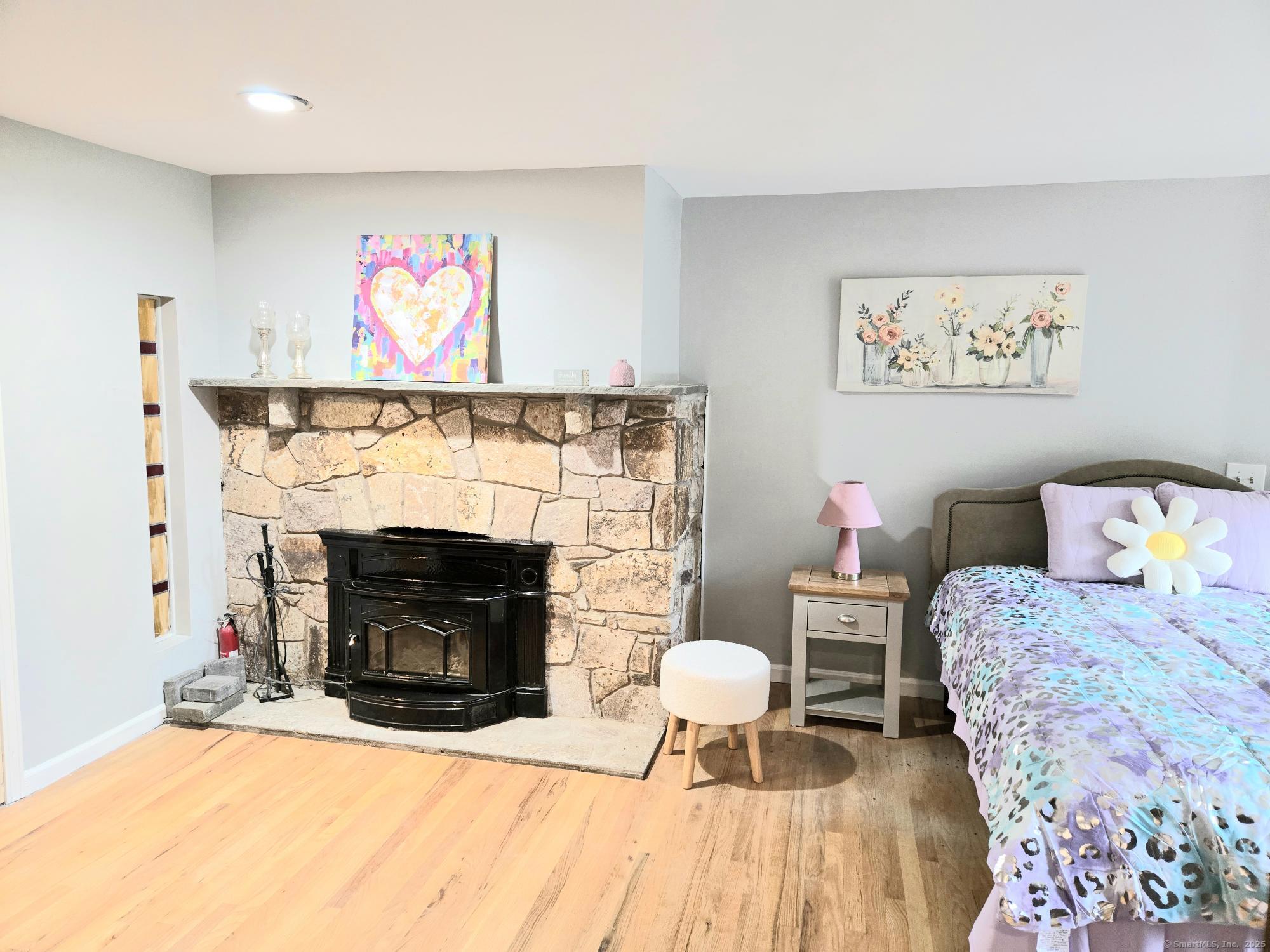 297 Wickham Road Glastonbury, CT 06033 - Photo 22 of 39 a living room with furniture and a fireplace