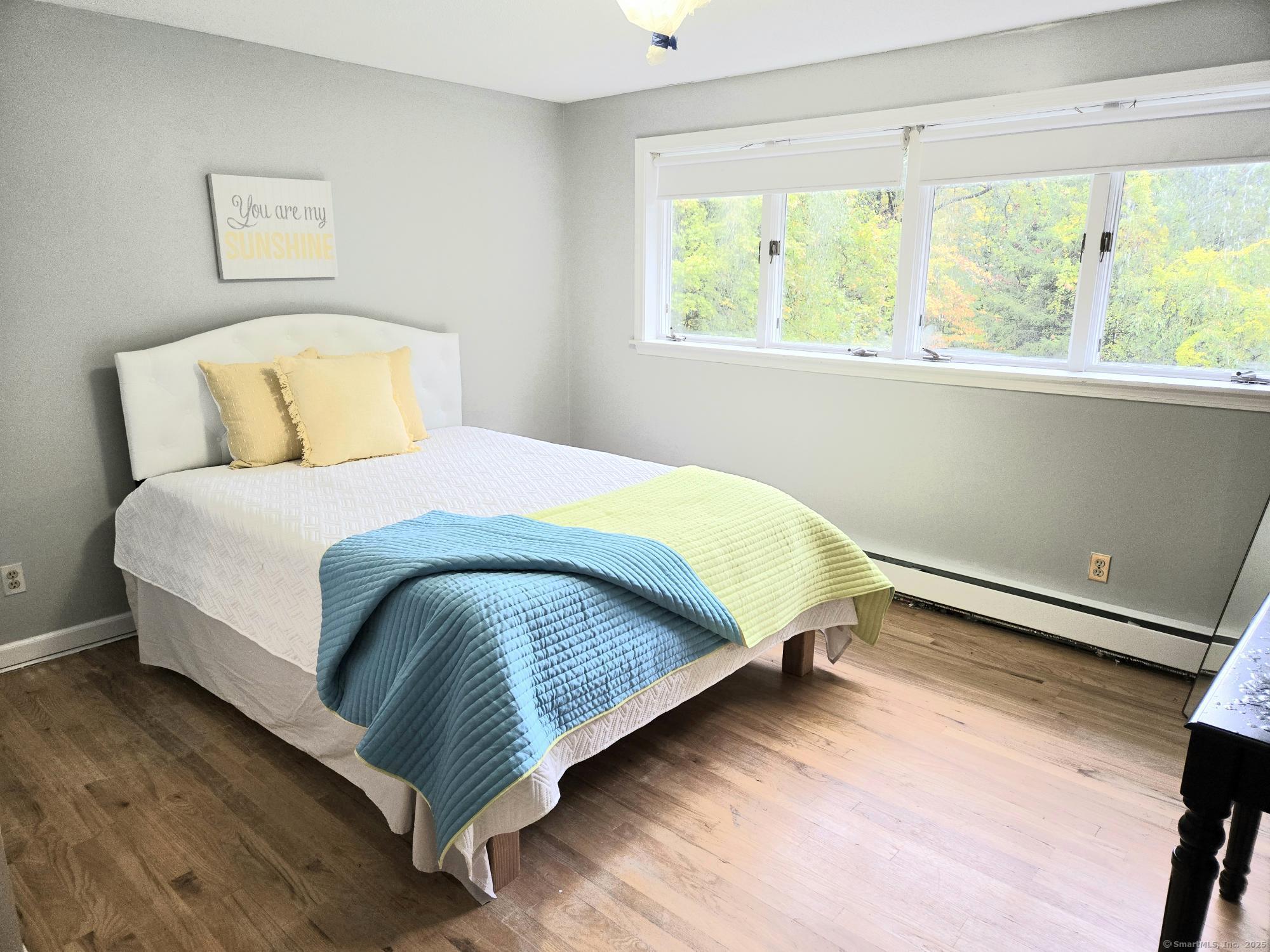 297 Wickham Road Glastonbury, CT 06033 - Photo 27 of 39 a bedroom with a bed lamp and window