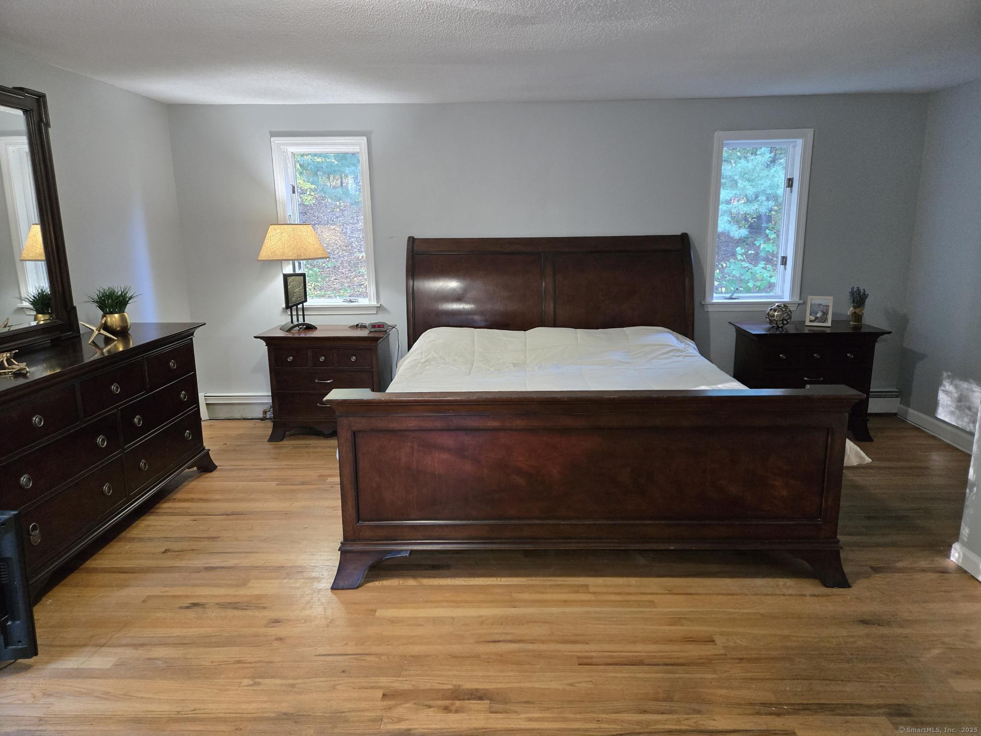 297 Wickham Road Glastonbury, CT 06033 - Photo 28 of 39 a bedroom with a bed and a dresser