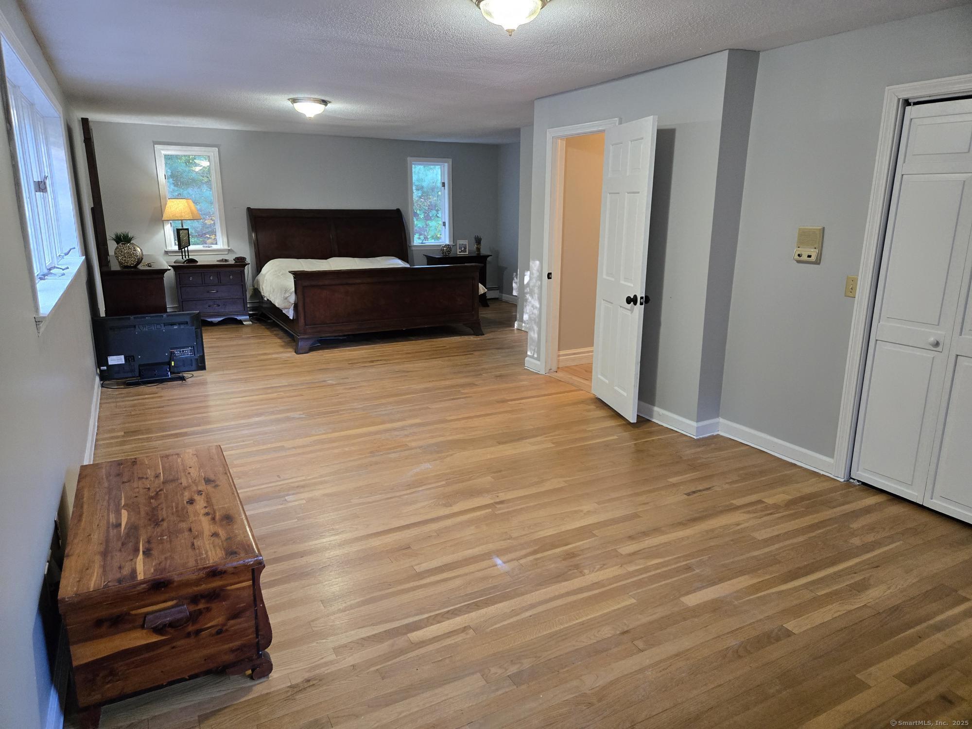 297 Wickham Road Glastonbury, CT 06033 - Photo 30 of 39 a living room with furniture and a wooden floor