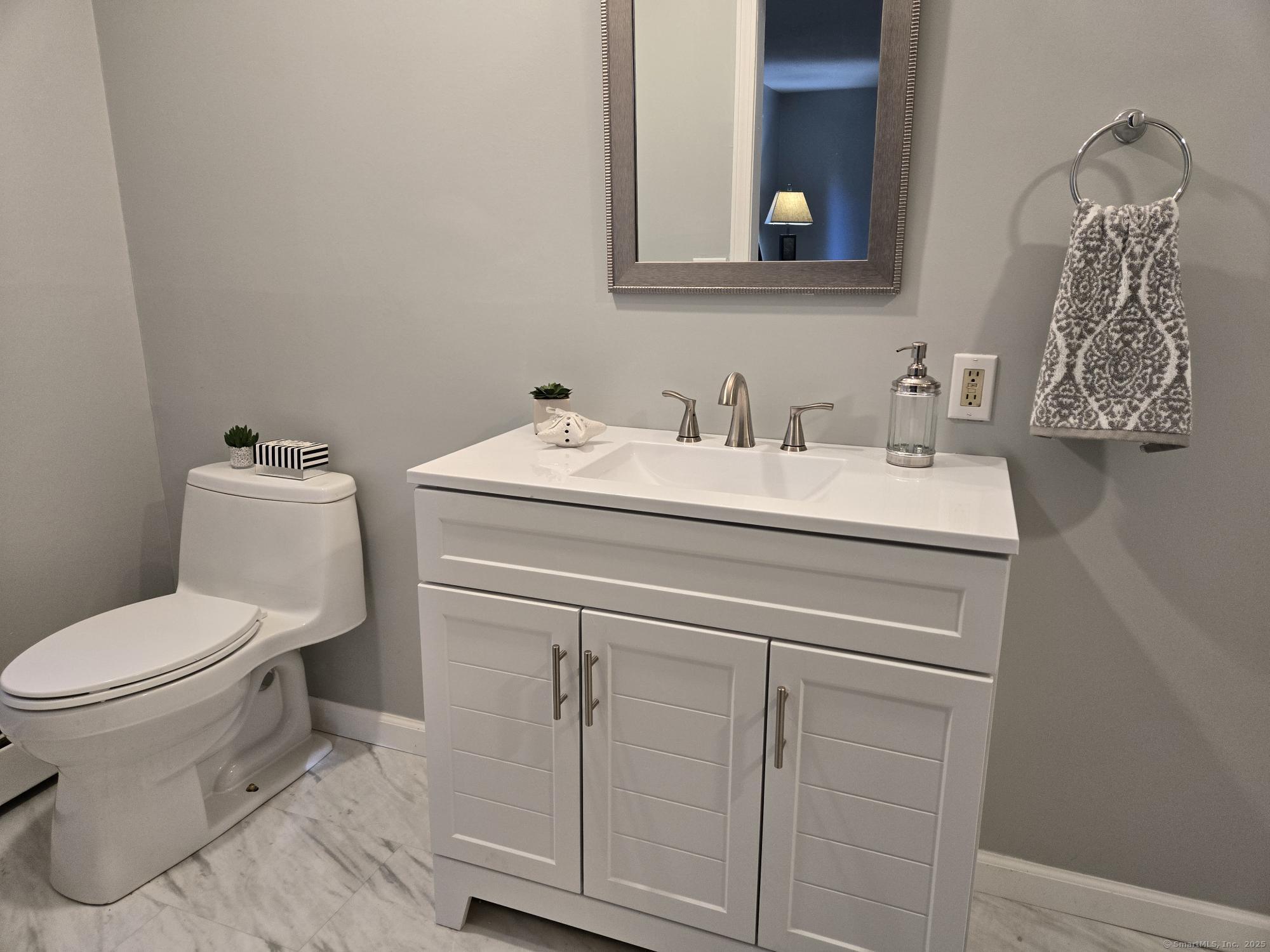 297 Wickham Road Glastonbury, CT 06033 - Photo 31 of 39 a bathroom with a toilet sink and mirror