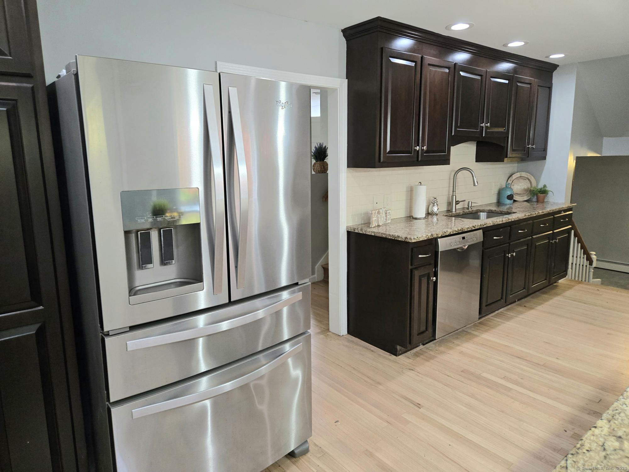297 Wickham Road Glastonbury, CT 06033 - Photo 5 of 39 a kitchen with stainless steel appliances granite countertop a refrigerator and a sink