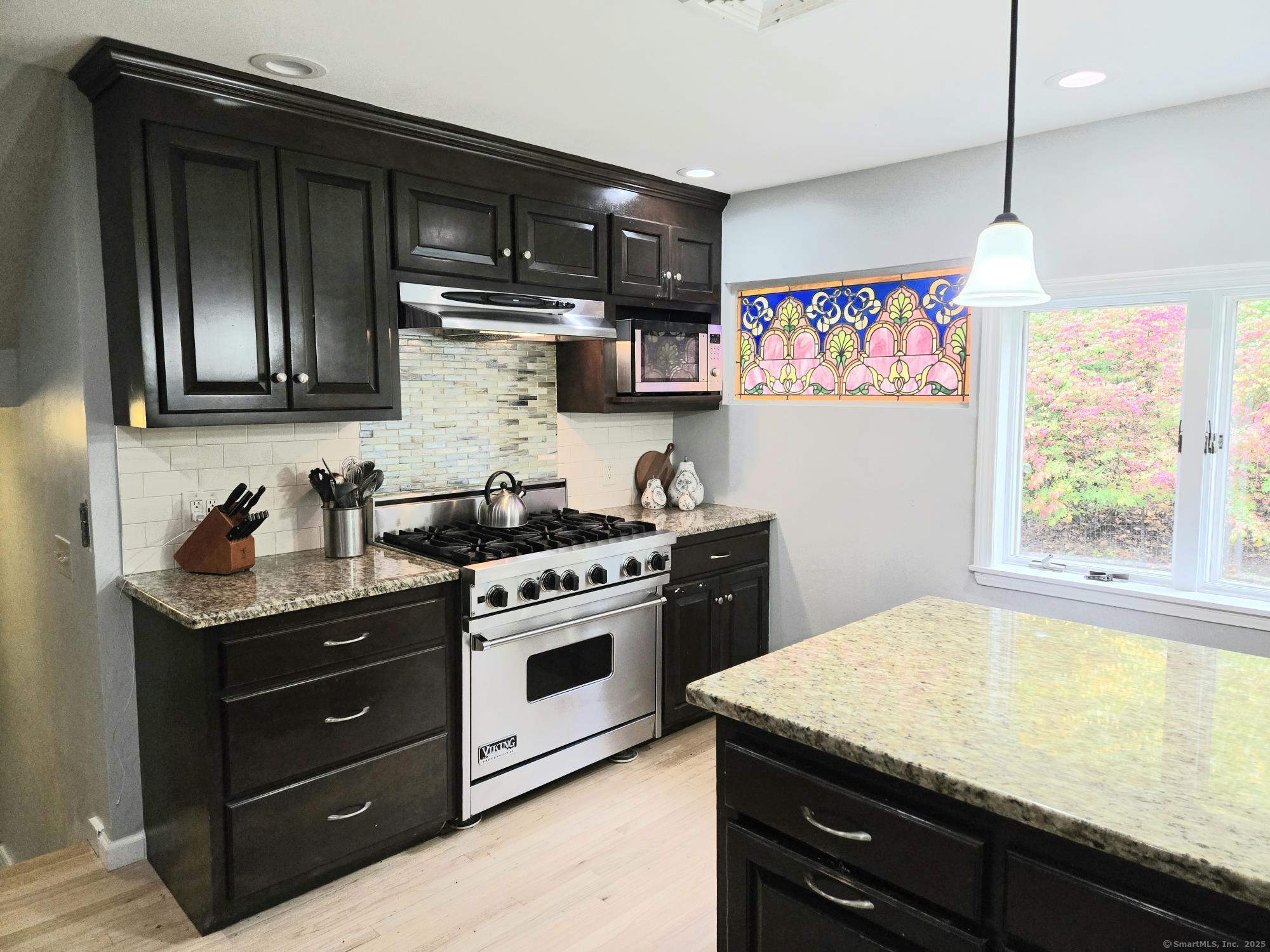 297 Wickham Road Glastonbury, CT 06033 - Photo 7 of 39 a kitchen with stainless steel appliances granite countertop a stove and a sink