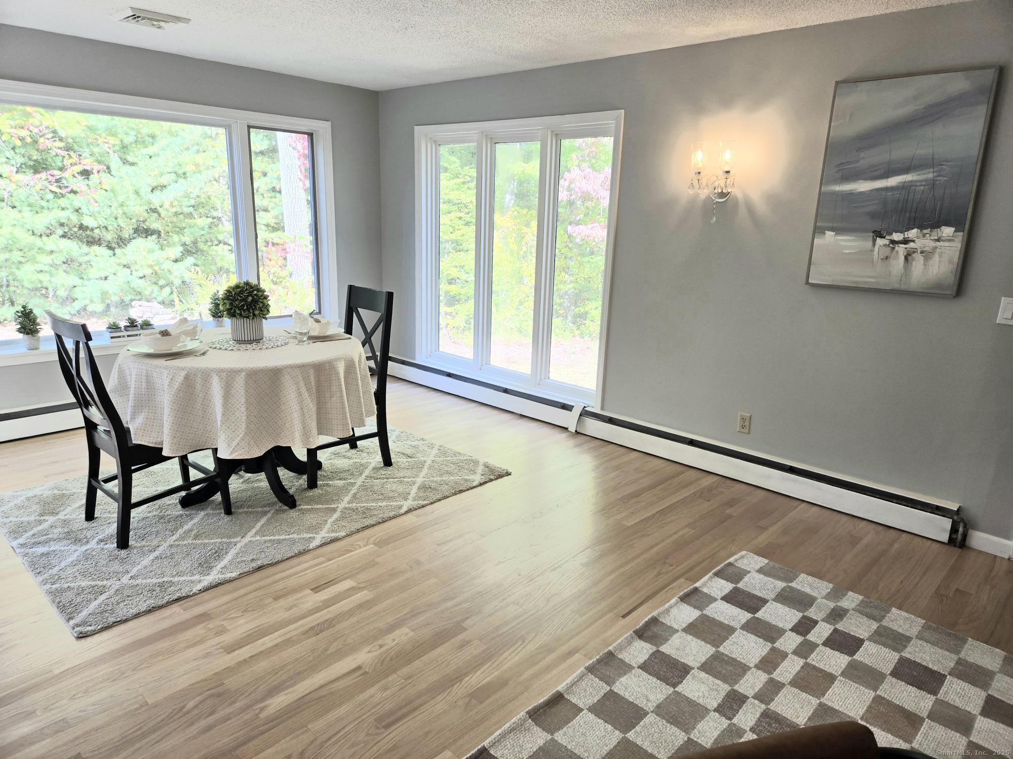 297 Wickham Road Glastonbury, CT 06033 - Photo 10 of 39 a view of a dining room with furniture and wooden floor