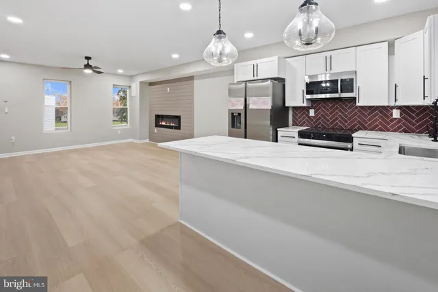 a large kitchen with granite countertop a stove oven and a sink