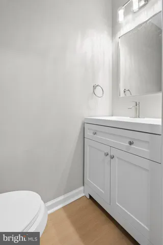 a bathroom with a sink a toilet and mirror