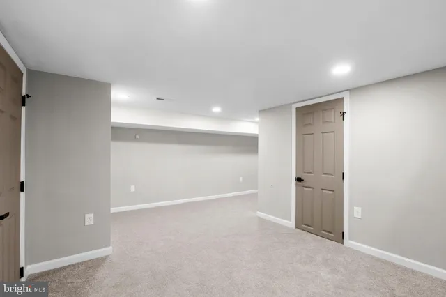 a white toilet sitting next to a bath tub