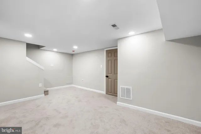 an empty room with a empty space and windows