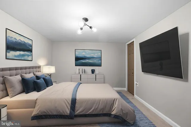 a bedroom with a bed and a flat screen tv