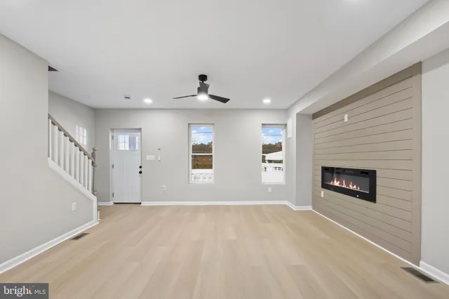 a view of a livingroom with a fireplace and window