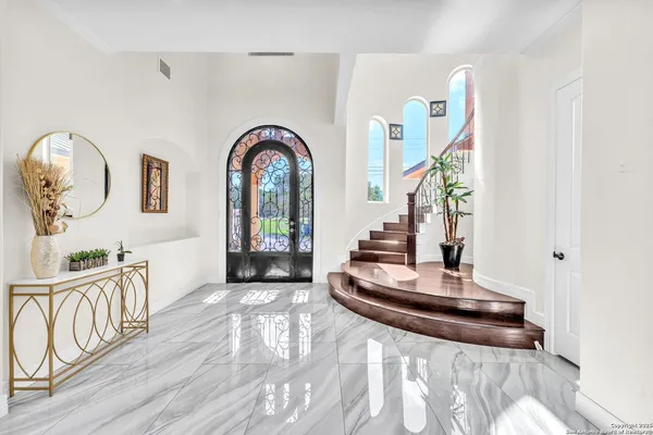 a view of entryway and hall with wooden floor