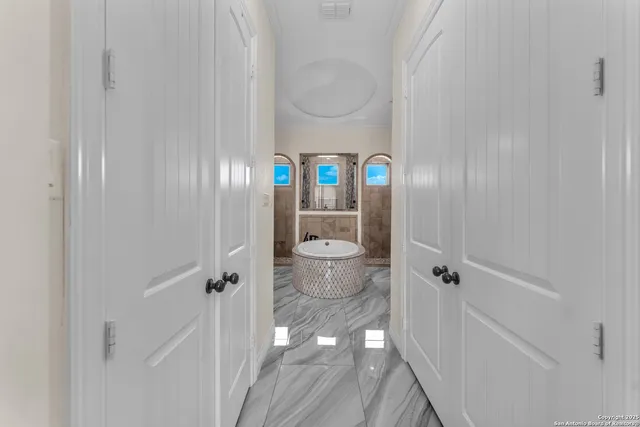 a view of a hallway with wooden floor