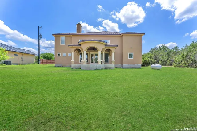 an aerial view of a house with a yard