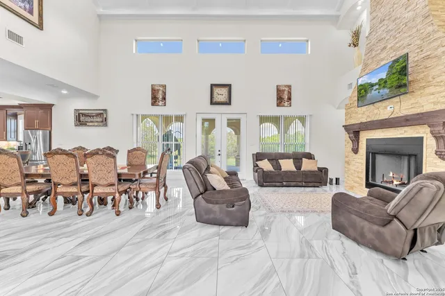 a living room with furniture wooden floor and a fireplace