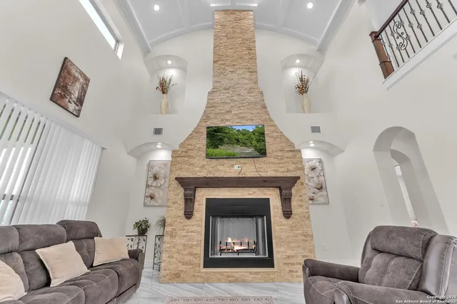 a living room with furniture and a fireplace