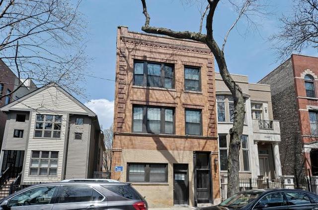 Undisclosed Address Chicago, IL 60622 - Photo 1 of 13 a front view of a residential apartment building with a yard