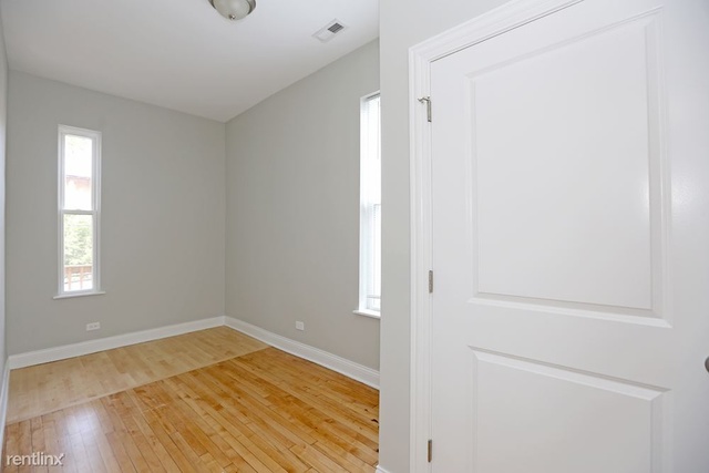 Undisclosed Address Chicago, IL 60622 - Photo 6 of 13 a view of empty room with wooden floor and fan