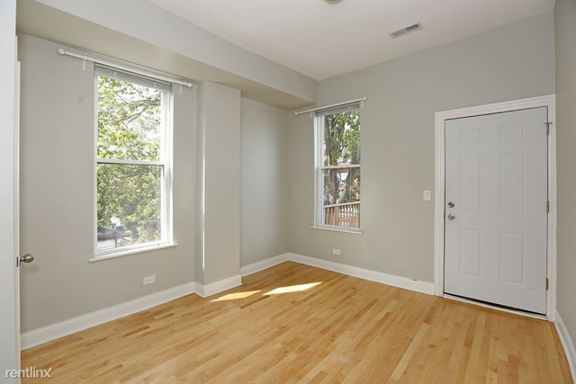 Undisclosed Address Chicago, IL 60622 - Photo 8 of 13 a view of an empty room with wooden floor and a window
