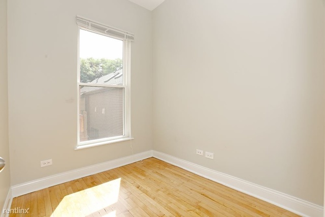 Undisclosed Address Chicago, IL 60622 - Photo 10 of 13 an empty room with wooden floor and windows
