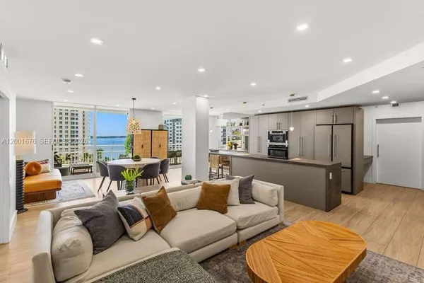 a living room with furniture and a kitchen view